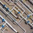 Aerial top view natural gas pipeline, gas industry, gas transport system, stop valves and appliances for gas pumping station.