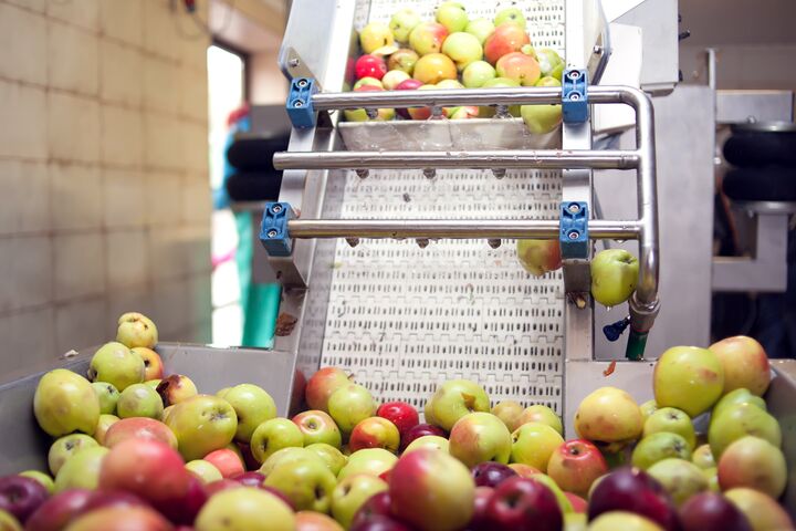 A processing of apples for fresh juice production. Food and healthy drinks concept