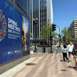 People walk past the International Monetary Fund (IMF), in Washington, DC, on April 17, 2022. The IMF and World Bank Group 2022 Sping Meeting will be held on April 18-24, 2022. (Photo by Daniel SLIM / AFP)