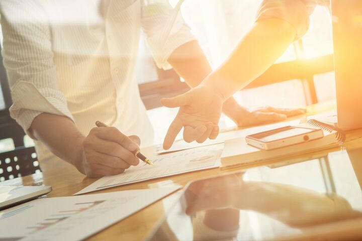 Team work success.business managers working with new startup project in modern office.Businessman adviser analyzing financial figures denoting the progress in the work of the company,vintage color