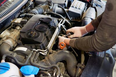 © Florentino - stock.adobe.com Ein Mechaniker arbeitet an einem Verbrennungsmotor. Der Verbrenner ist ab 2035 bei Pkw nicht mehr erlaubt.