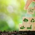 Net Zero and Carbon Neutral Concepts Net Zero Emissions Goals A climate-neutral long-term strategy Ready to put wooden blocks by hand with green net center icon and green icon on gray background.
