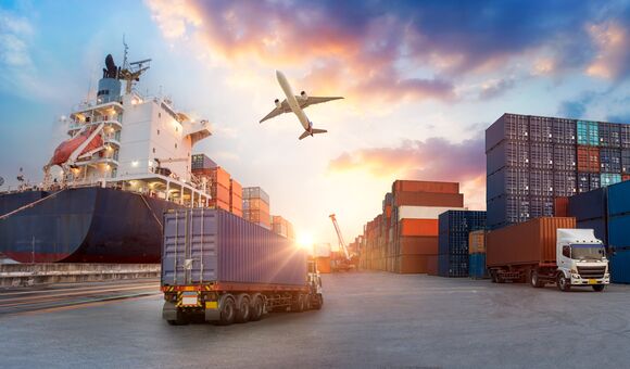 Container truck in ship port for business Logistics and transportation of Container Cargo ship and Cargo plane with working crane bridge in shipyard at sunrise, logistic import export and transport industry background