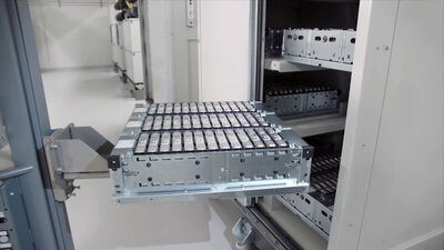 © Getty Images/iStockphoto close-up of an electric car battery on top of a forklift truck going into a cabinet where there are more batteries. In an electric car battery factory.