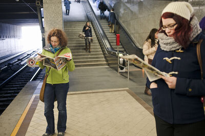 © Getty Images "Vienna, Austria - March 12, 2013: People are on the metro station two woman reading while waiting their trains."