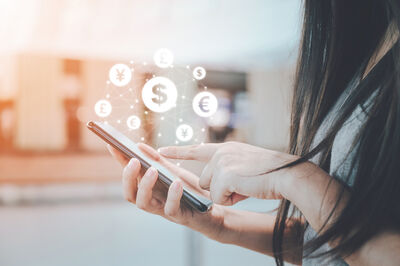 © Getty Images/iStockphoto Close up image hand using mobile phone with online transaction application, Concept financial technology (fin-tech) and ICO Initial coin offering business financial internet innovation technology