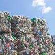 Stack of plastic bottles for recycling against blue sky
