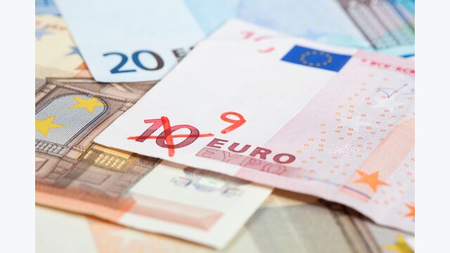 Background of Euro banknotes on the ground, one 10 Euro note with the 10 crossed out and a 9 written on it. Short Depth of field with front and back part blurred out of focus.