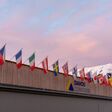 Davos, GR / Switzerland - 14 January 2020: the congress center in Davos with flags of nations at sunrise during the WEF World Economic Forum