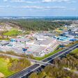 Industrial complex and commercial area beside a highway in Austria seen from the air as example for massive sealing of soil