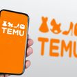 Boston, US, March 2023: Hand holding a phone with Temu logo displayed on the screen. Blurred logo on the background. Temu is an online marketplace. Illustrative editorial
