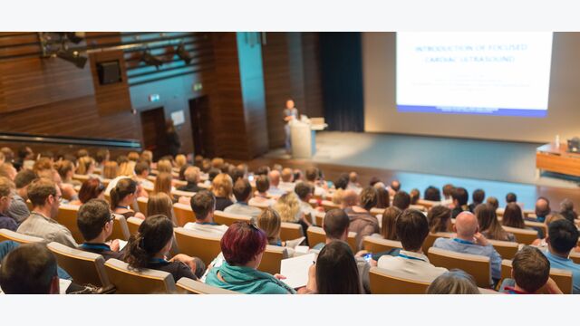 Speaker giving a talk on scientific conference. Audience at the conference hall. Business and Entrepreneurship concept.