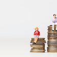 Gender pay equality concept. man and woman on a stack of coins.