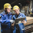 Zwei Techniker in Lagerhalle mit gemeinsamen Tablet
