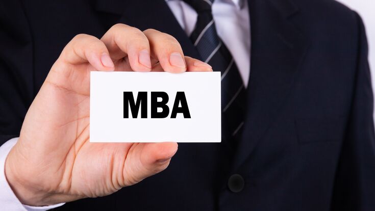 Businessman holding a card with text MBA