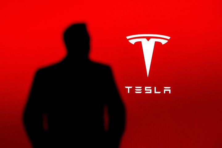 NEW YORK, USA, 2. OCTOBER 2022: Silhouette of business magnate and investor Elon Musk, Tesla Company logo in background