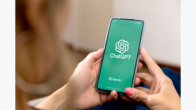 Woman using a mobile phone with ChatGPT on the screen. This app is a chatbot based on Artificial Intelligence developed by OpenAI.