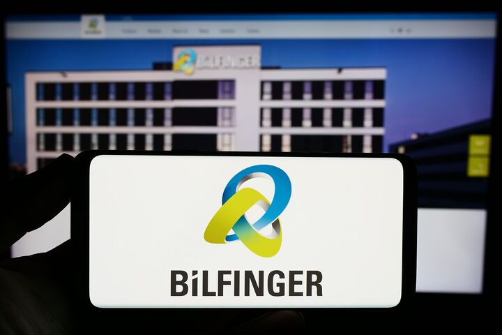 Stuttgart, Germany - 09-14-2023: Person holding smartphone with logo of German construction company Bilfinger SE on screen in front of website. Focus on phone display.