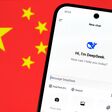 DeepSeek AI app chat seen on the smartphone and blurred Chinese flag on the background. Concept for a new chinese AI rival to ChatGPT. Stafford, United Kingdom, January 26, 2025