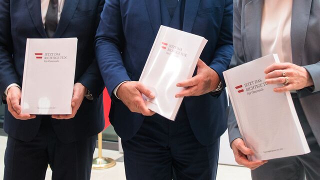 (L-R): Chairman of the Social Democratic Party of Austria (SPOe) Andreas Babler, Chairman of the Austrian People's Party (OeVP) Christian Stocker and Chairwoman of the liberal NEOS Beate Meinl-Reisinger hold copies of their parties' coalition program at the parliament in Vienna, Austria, on February 27, 2025. (Photo by Alex HALADA / AFP)