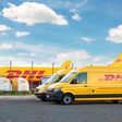 Schkeuditz, Germany - 29th May, 2022 - Many courier van against cargo planes parked on Leipzig Halle airport terminal apron for loading distribution. DHL air mail express fast logistic hub terminal.