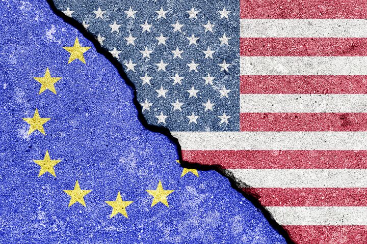 The crack between the flags of the United States and the European Union. The concept of problems in the relations of countries, trade tariffs and disagreements.