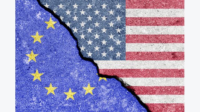 The crack between the flags of the United States and the European Union. The concept of problems in the relations of countries, trade tariffs and disagreements.
