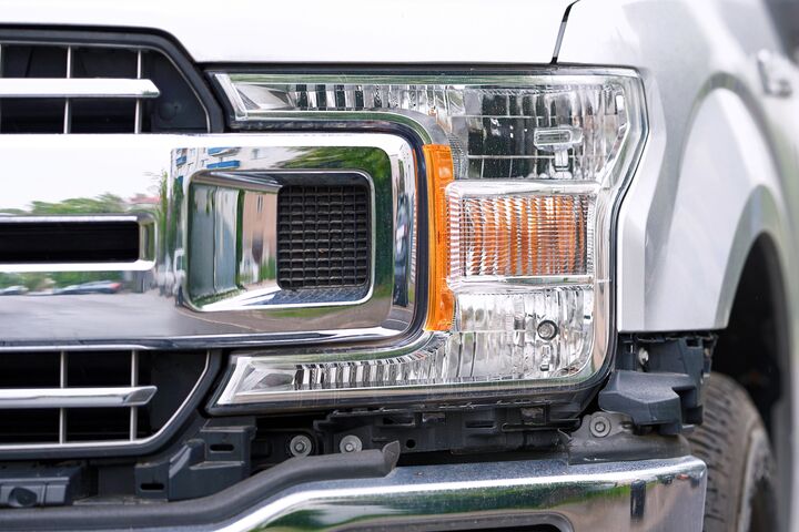 Minsk, Belarus. May 10, 2024. Ford truck F-150 XLT headlight closeup, sleek and modern design of the headlamp. F150 without front bumper cover grille upper molding. Selective focus