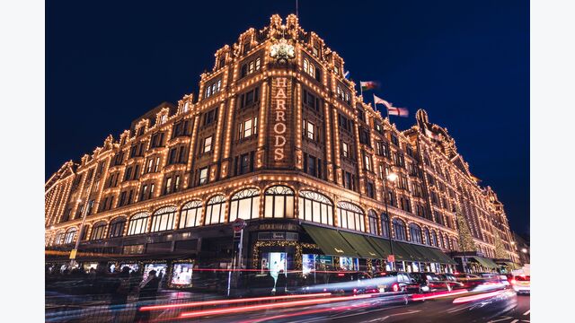 LONDON - DECEMBER 18, 2019: Harrods London department store shop at night with lights
