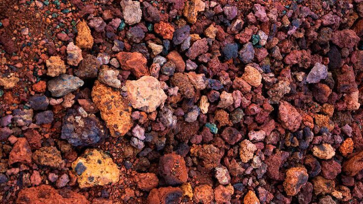 © piksik - stock.adobe.com Red and pink rough volcanic stones in a quarry in Iceland. Textured background