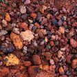 Red and pink rough volcanic stones in a quarry in Iceland. Textured background