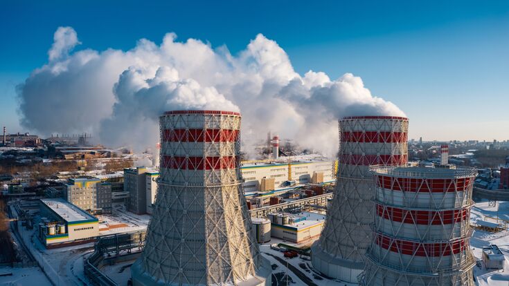 Concept of environmental pollution, drone view of smokestack pipe steel plant, aerial industrial panoramic landscape with blue sky in winter evening, air emissions from manufacturing sector,Russia