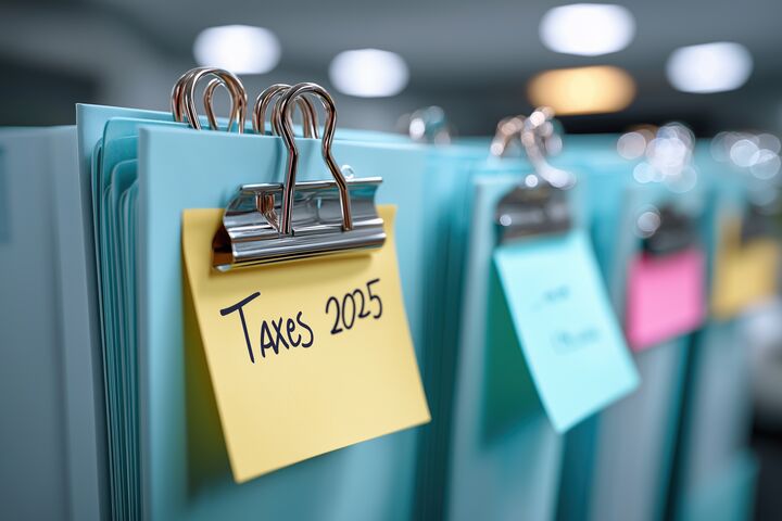 Close-up of organized office folders with tax reminder