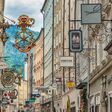 Salzburg, Austria - May 19,2019 : city skyline and wrought iron signs at Grain Lane street the famous shopping street of Salzburg Austria
