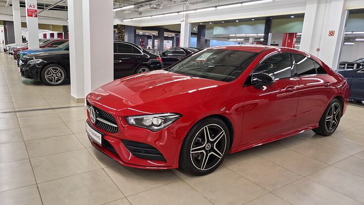 Russia, Moscow- 23 November 2025. Sleek red mercedes-benz in contemporary car showroom setting