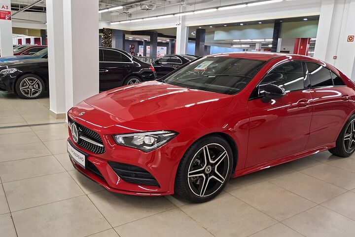 Russia, Moscow- 23 November 2025. Sleek red mercedes-benz in contemporary car showroom setting