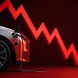 Electric vehicle with charging cable and a red downward trend line indicating a drop in ev sales.