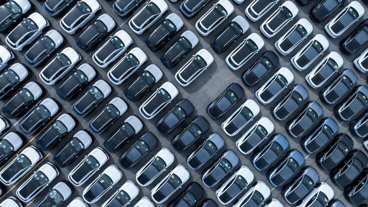 Aerial view car for sale stock lot row, Cars dealership inventory distribution automobile and automotive business, New cars parking for sale automobile automotive industry business.