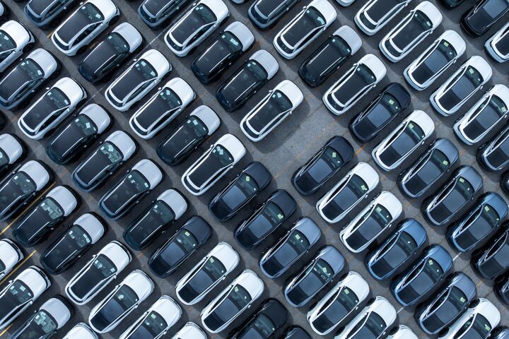 Aerial view car for sale stock lot row, Cars dealership inventory distribution automobile and automotive business, New cars parking for sale automobile automotive industry business.