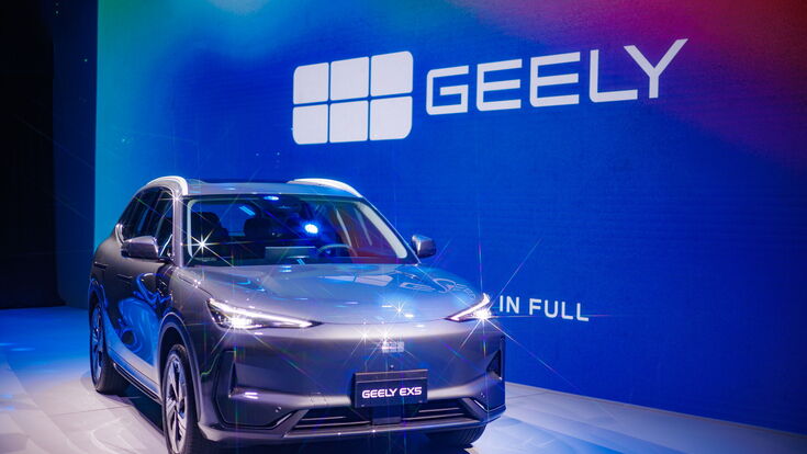 Geely EX5 auf einer Präsentationsbühne mit großem Geely-Logo im Hintergrund