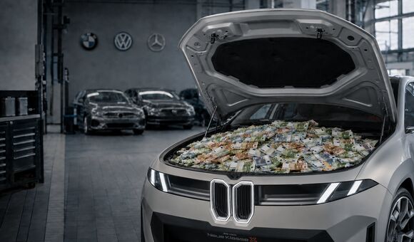 Ein grauer BMW steht in einer Werkstatt mit geöffneter Motorhaube, darunter liegen viele Euro-Scheine. Im Hintergrund sind unscharf die Logos von BMW, Volkswagen und Mercedes zu sehen.