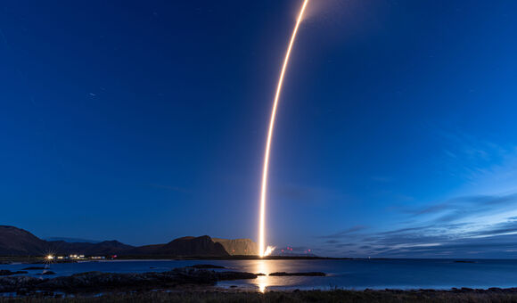 Isar Aerospace Rakete bei Start: Leuchtendes Lichtband vor blauem dunklem Himmel