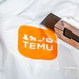 Aachen, Germany - February 21, 2024: Shipping package of TEMU a giant new Chinese mail order company.