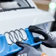 Audi Ringe werden auf ein Fahrzeug montiert