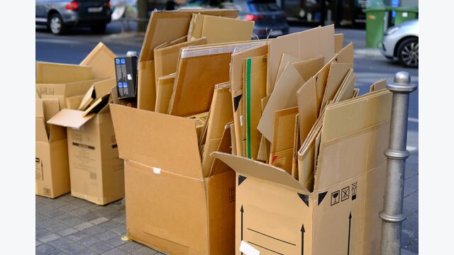 broken cardboard boxes with waste paper, next to paper recycling bin recycling problem, urban waste management, raw material for recycling, environmental contamination and neglect