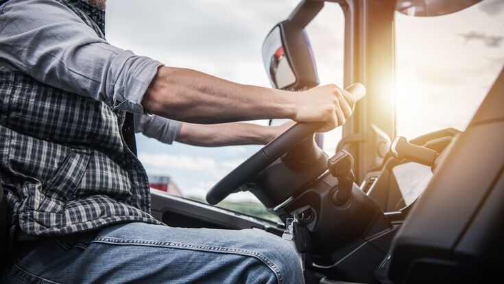 Truck Driver Behind the Wheel. Semi Truck Driving and Transportation Industry.