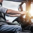 Truck Driver Behind the Wheel. Semi Truck Driving and Transportation Industry.