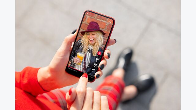 Woman viewing social media content on mobile phone