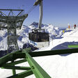 Lech, Austria - February 07, 2011: The Rufibahn cable car descending from the Rufikopf Bergstation. Skiers are looking at the cable car and surrounding views. Lech is a well known ski resort in the Austrian Alps.